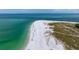 Aerial view of a beach with people enjoying the sun and water at 727 Holly Rd, Anna Maria, FL 34216