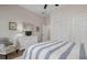 Bedroom with white dresser, striped bedding, and built-in closet at 727 Holly Rd, Anna Maria, FL 34216