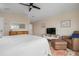 King bedroom with TV and seating area at 727 Holly Rd, Anna Maria, FL 34216