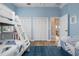 Bedroom with twin and full-size bunk beds and access to a balcony at 727 Holly Rd, Anna Maria, FL 34216