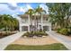 Two-story house with a charming exterior, landscaping, and driveway at 727 Holly Rd, Anna Maria, FL 34216