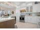 Modern kitchen featuring white cabinets and stainless steel appliances at 727 Holly Rd, Anna Maria, FL 34216