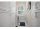 Bright laundry room with white cabinets and a window at 727 Holly Rd, Anna Maria, FL 34216