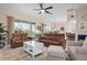 Open concept living room with leather sofas and a view of the kitchen at 727 Holly Rd, Anna Maria, FL 34216