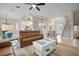 Bright living room with leather seating, high ceilings and views to kitchen at 727 Holly Rd, Anna Maria, FL 34216