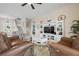 Open living room showcasing a staircase, comfortable seating, and a large TV at 727 Holly Rd, Anna Maria, FL 34216