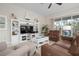 Spacious living room featuring comfortable leather sofas and built-in shelving at 727 Holly Rd, Anna Maria, FL 34216