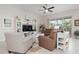 Spacious living area featuring brown leather sofas and a white entertainment center at 727 Holly Rd, Anna Maria, FL 34216