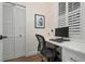 Home office with built-in desk and window with shutters at 727 Holly Rd, Anna Maria, FL 34216
