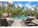Inviting pool area with lounge chairs, lush landscaping, and a relaxing atmosphere at 727 Holly Rd, Anna Maria, FL 34216