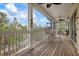 Relaxing screened porch with wooden flooring and outdoor seating at 727 Holly Rd, Anna Maria, FL 34216