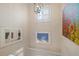 Stairwell with framed artwork and a modern light fixture at 727 Holly Rd, Anna Maria, FL 34216