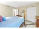 Bedroom with a wooden post bed, light blue bedding, and built-in closet at 752 Tropical Cir, Sarasota, FL 34242