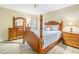 Bedroom with a wooden bed frame and light blue bedding, plus dresser and nightstand at 752 Tropical Cir, Sarasota, FL 34242
