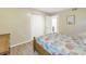 Bedroom with wooden bed frame and coastal bedding, next to a closet and bathroom at 752 Tropical Cir, Sarasota, FL 34242