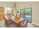 Open dining area with large wooden table and view of pool at 752 Tropical Cir, Sarasota, FL 34242