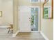 Bright entryway with white door and wood-look tile flooring at 752 Tropical Cir, Sarasota, FL 34242