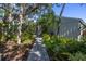 Brick walkway leads to charming home entrance, surrounded by lush landscaping at 752 Tropical Cir, Sarasota, FL 34242
