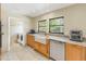 Kitchen features granite countertops, farmhouse sink, and laundry access at 752 Tropical Cir, Sarasota, FL 34242
