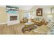 Bright living room with comfy seating and a cozy fireplace at 752 Tropical Cir, Sarasota, FL 34242