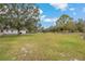 Open grassy backyard with mature trees at 7565 64Th E Ct, Palmetto, FL 34221