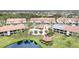 Community overview showcasing villas, pool, and pond at 764 Avenida Estancia # 208, Venice, FL 34292