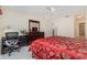 Bedroom with red bedding and built-in desk at 764 Avenida Estancia # 208, Venice, FL 34292