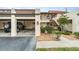 Spanish style condo building with attached garage and lush landscaping at 764 Avenida Estancia # 208, Venice, FL 34292