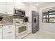 White kitchen with granite countertops at 764 Avenida Estancia # 208, Venice, FL 34292