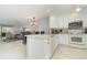 Modern white kitchen with stainless steel appliances at 764 Avenida Estancia # 208, Venice, FL 34292