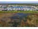 Aerial view of community with lake and homes at 8050 Redonda Loop, Lakewood Ranch, FL 34202