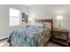 Cozy bedroom with a full-size bed and wood accents at 8050 Redonda Loop, Lakewood Ranch, FL 34202