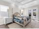 Bright bedroom with a queen-size bed and access to a patio at 8050 Redonda Loop, Lakewood Ranch, FL 34202