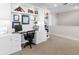 Bright home office features built-in shelving and a large desk at 8050 Redonda Loop, Lakewood Ranch, FL 34202