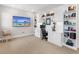 Spacious home office with a large TV and comfortable seating at 8050 Redonda Loop, Lakewood Ranch, FL 34202