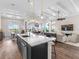Open kitchen with large island overlooking living and dining areas at 8050 Redonda Loop, Lakewood Ranch, FL 34202