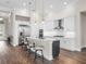 Modern kitchen with white cabinets, marble counters, and stainless steel appliances at 8050 Redonda Loop, Lakewood Ranch, FL 34202