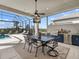 Covered outdoor kitchen with dining area and built in TV at 8050 Redonda Loop, Lakewood Ranch, FL 34202