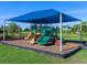Community playground with shade structure and slides at 8050 Redonda Loop, Lakewood Ranch, FL 34202
