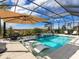 Luxury pool and patio with covered lanai and built in seating at 8050 Redonda Loop, Lakewood Ranch, FL 34202
