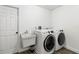 Clean laundry room featuring modern washer and dryer units and a utility sink at 8273 Annapolis Rd, Spring Hill, FL 34606