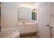 Bathroom with vanity, large mirror, and bathtub at 8282 Parkside Dr, Englewood, FL 34224