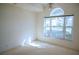 Bedroom with large window and carpet flooring at 8282 Parkside Dr, Englewood, FL 34224