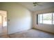 Spacious bedroom with large window and ceiling fan at 8282 Parkside Dr, Englewood, FL 34224