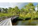 Boardwalk path over water with lush green vegetation at 8282 Parkside Dr, Englewood, FL 34224