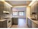 Modern kitchen with gray cabinets, quartz countertops, and stainless steel appliances at 8282 Parkside Dr, Englewood, FL 34224