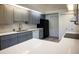 Gray cabinets, quartz countertops, and stainless steel appliances at 8282 Parkside Dr, Englewood, FL 34224