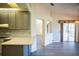 Open concept kitchen with gray cabinets, island and breakfast bar at 8282 Parkside Dr, Englewood, FL 34224