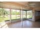 Sunroom with tiled floor and plenty of natural light at 8282 Parkside Dr, Englewood, FL 34224