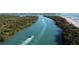 Aerial view of a waterway with boats and paddleboarders at 8282 Parkside Dr, Englewood, FL 34224